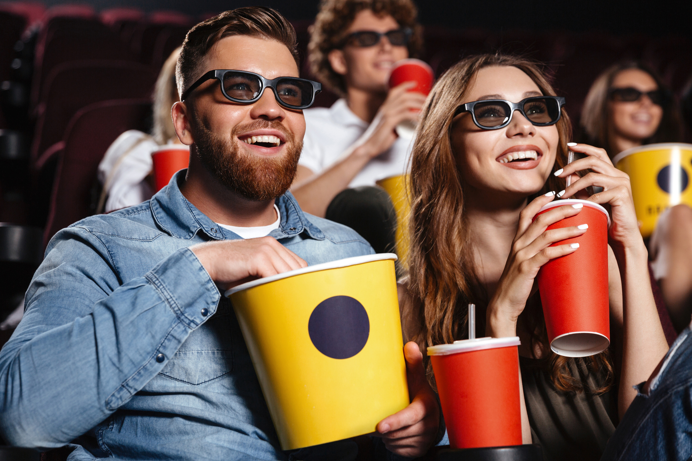 Happy Friends Sitting in Cinema