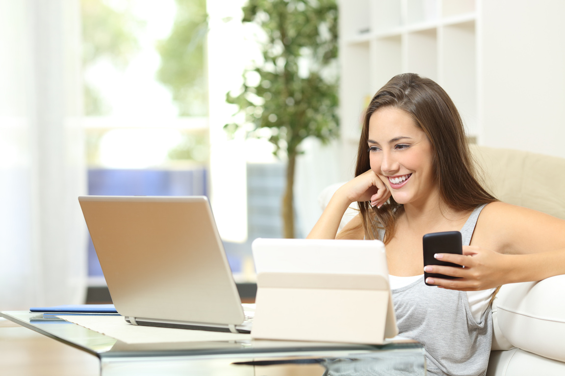 Woman working with multiple devices